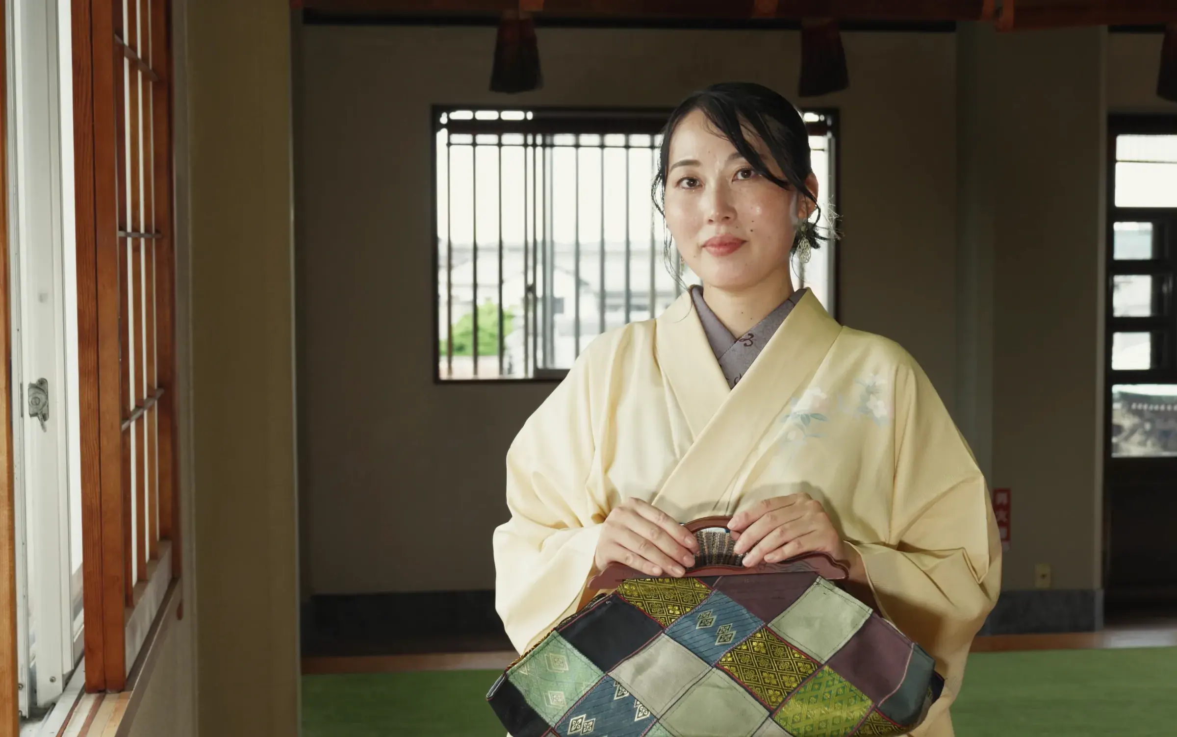 Holding the Hishi handbag in the temple hall