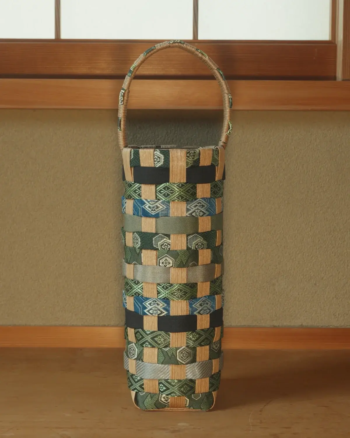 Aotake — Green, cobalt and black, with a pale woven handle. A small one.