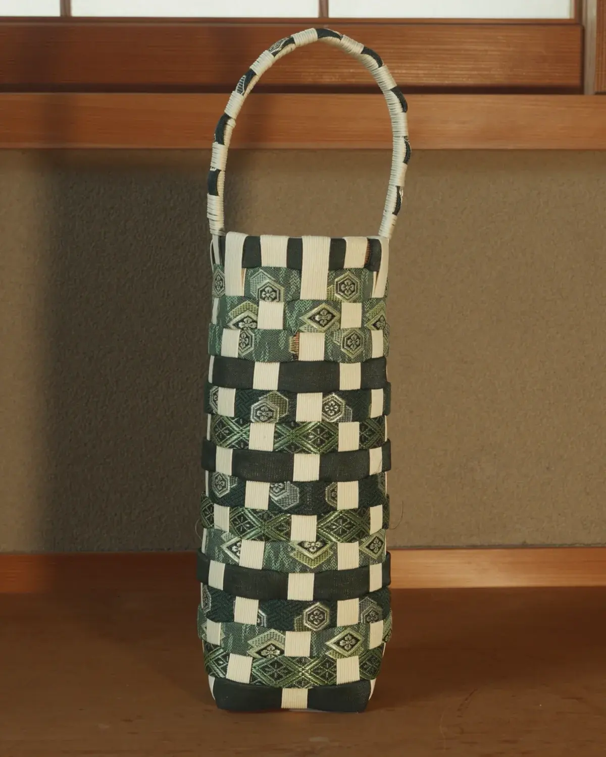 Yoru — Black-green and cream in a bold check, under a cream handle.