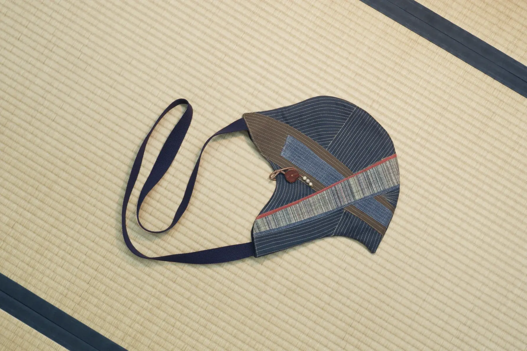 Shima — Navy and grey kimono stripes pieced into a crescent, with a navy strap.